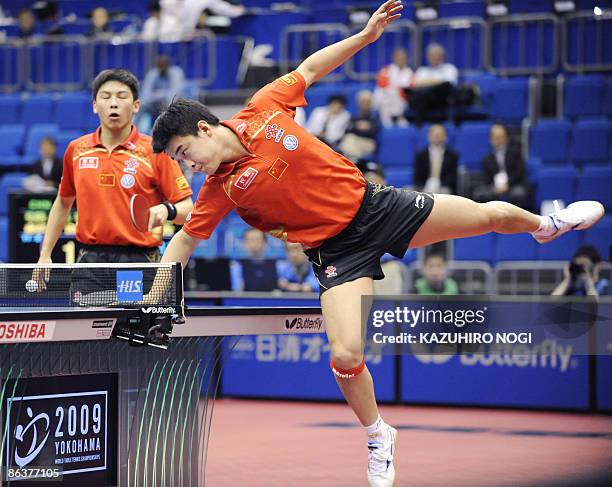 China's Wang Hao ties to return the ball as his partner Chen Qi looks on during the men's semi-finals against their compatriots Hao Shuai and Zhang...