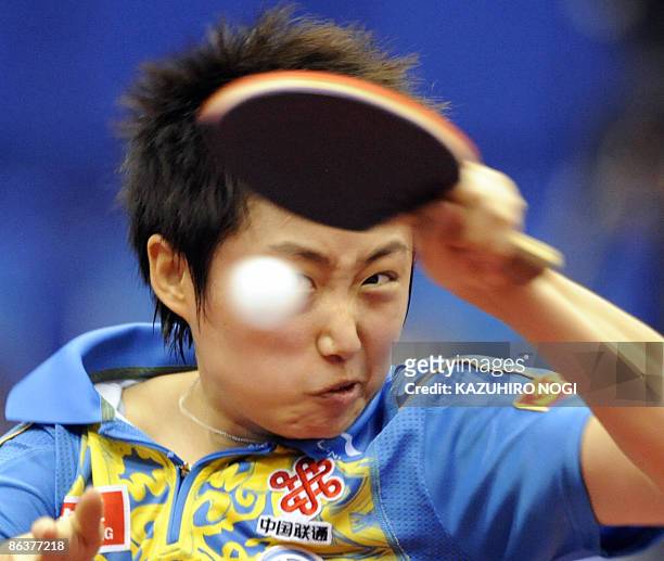 China's Guo Yue smashes the ball against her compatriot opponent Li Xiaoxia during their women's semi-final match of the World Table Tennis...
