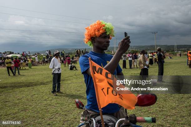 Supporter used his cellphone during a rally for opposition candidate Raila Odinga at the Ogango Grounds on October 20, 2017 in Kisumu, Kenya....