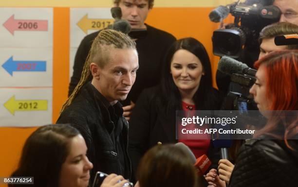 Ivan Bartos, chairman of the Czech pirate Party speaks to journalists after casting his ballot at a polling station during the first day of voting in...