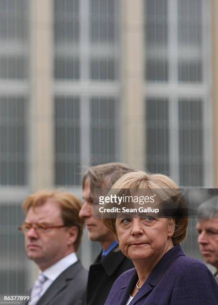 German Chancellor Angela Merkel tours the former prison of the East German, communist-era secret police, known as the Stasi, at Hohenschoenhausen on...