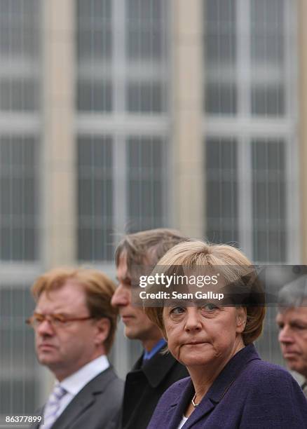 German Chancellor Angela Merkel tours the former prison of the East German, communist-era secret police, known as the Stasi, at Hohenschoenhausen on...