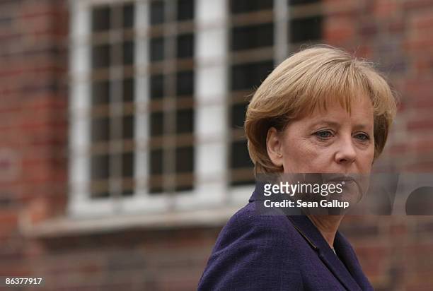 German Chancellor Angela Merkel tours the former prison of the East German, communist-era secret police, known as the Stasi, at Hohenschoenhausen on...