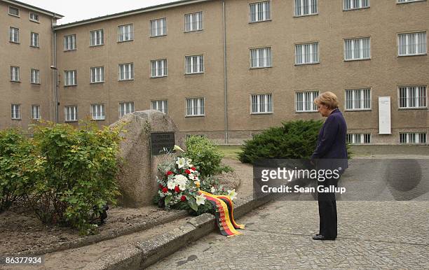 German Chancellor Angela Merkel lays a wreath while touring the former prison of the East German, communist-era secret police, known as the Stasi, at...