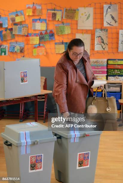 Woman casts his ballot at a polling station during the first day of voting in the Czech elections on October 20, 2017 in Prague, Czech Republic....