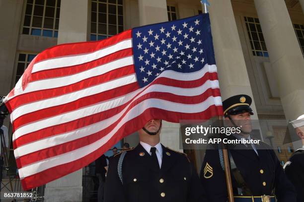 Soldier is blinded by the US flag as US Secretary of Defense Jim Mattis hosts Florence Parly, French Defense minister, at the Pentagon for a meeting...