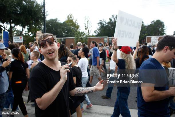 Self-described white nationalist Colton Fears, of Pasadena, Texas, films with his cell phone as demonstrators gather near the site of a planned...