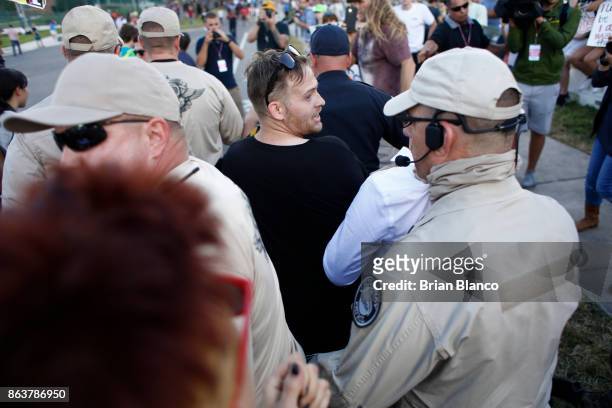 Self-described white nationalist Colton Fears, of Pasadena, Texas, center, walks inside a group of Florida Highway Patrol troopers as the troopers...