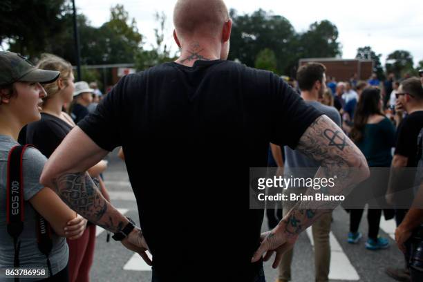 Self-described white nationalist Tyler Tenbrink, of Houston, Texas, watches as demonstrators gather near the site of a planned speech by Richard...