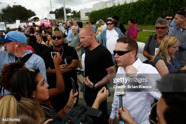 Self-described white nationalist Tyler Tenbrink, of Houston, Texas, center, and friend William Fears, right, speak to members of the media as...