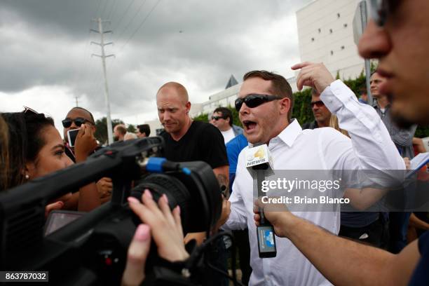 Self-described white nationalist Tyler Tenbrink, of Houston, Texas, left, and friend William Fears, speak to members of the media as demonstrators...