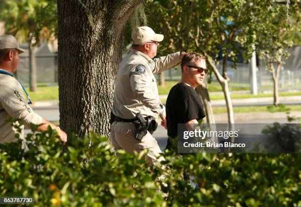 Self-described white nationalist Colton Fears, of Pasadena, Texas, is escorted by Florida Highway Patrol troopers as the troopers assist his...