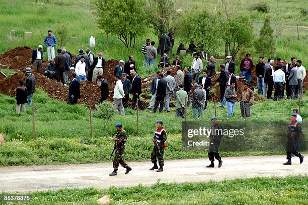 Villagers dig graves on May 5, 2009 in the Turkish village of Bilge outside the southeastern Kurdish city of Mardin after masked gunmen stormed late...