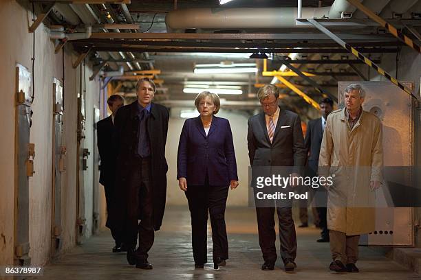 German Chancellor Angela Merkel speaks to current prison memorial director Hubertus Knabe , State Secretary Andre Schmitz and former inmate Gilbert...