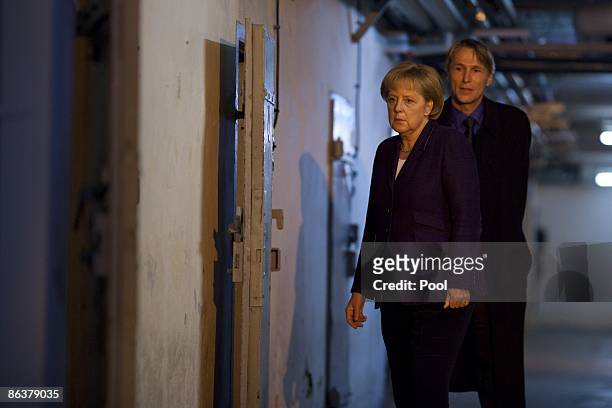 German Chancellor Angela Merkel is followed by current prison memorial director Hubertus Knabe while touring the former prison of the East German,...