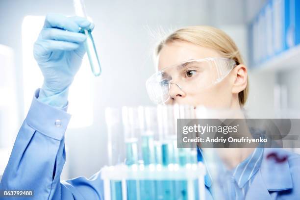 young woman working in laboratory - test tubes stock-fotos und bilder