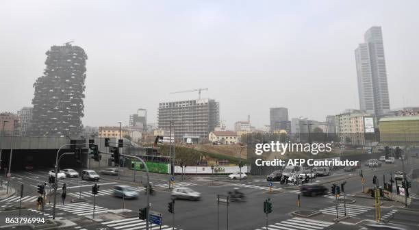 Cars drive on a street in Milan on October 20 as smog has reached alarming levels in northern Italy in recent days. Drivers in Milan will face a...