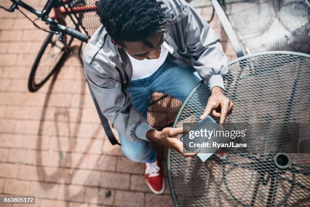 young man doing remote deposit capture of check - deposit slip stock pictures, royalty-free photos & images