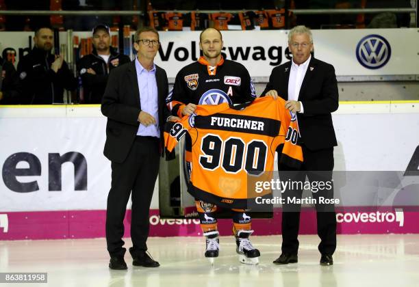 Sebastian Furchner of Wolfsburg is hoinored for 900 DEL matches before the DEL match between Grizzlys Wolfsburg and Adler Mannheim at Eisarena...