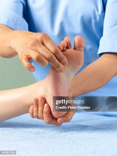 physiotherapist giving foot massage. - heels hand stock-fotos und bilder