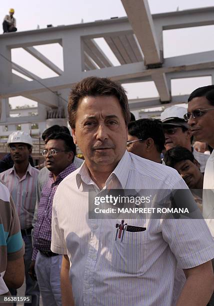 Indian hockey coach Jose Brasa smiles during his visit to the Dhyan Chand National Stadium to inspect the ongoing work for the 2010 commonwealth...