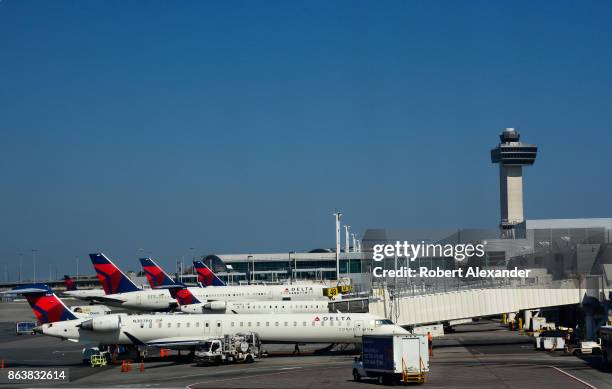 Delta Airlines and Delta Connection passenger jets are serviced at John F. Kennedy International Airport in New York, New York, in the shadow of the...