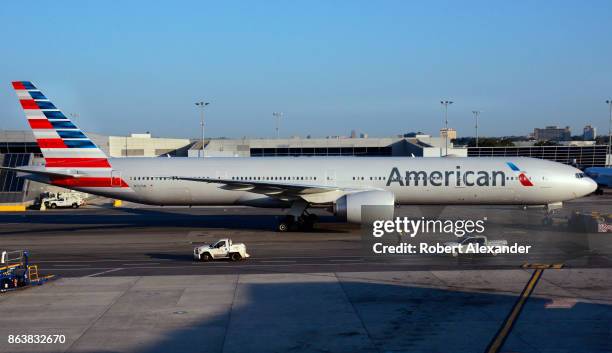 An American Airlines Boeing 777 passenger jet is towed to a gate at John F. Kennedy International Airport in New York, New York.