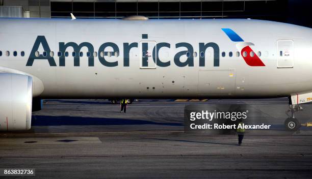 An American Airlines Boeing 777 passenger jet is towed to a gate at John F. Kennedy International Airport in New York, New York.