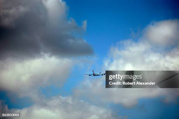 British Airways passenger plane flies into the clouds after lifting off from Heathrow International Airport in London, England.