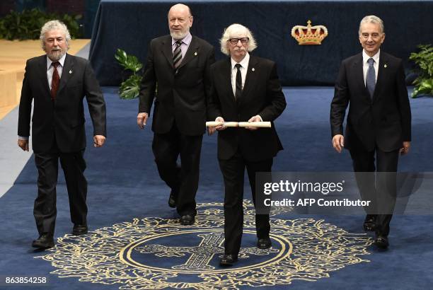Members of Argentinian comedy-musical group Les Luthiers Carlos Nunez, Marcos Mundstock, Carlos Lopez Puccio and Jorge Luis Maronna acknowledge the...