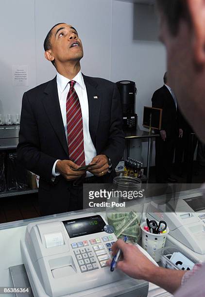 President Barack Obama looks at a menu as he orders lunch at Ray's Hell Burger May 5, 2009 in Arlington, Virginia. Obama and Biden made an unannouced...