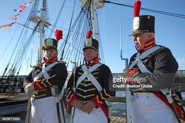 From left, Members of the 1812 Marine Guard Stan Kumor, Dan Dono and Tom Rudder stand on the USS Constitution as the ship makes a voyage across...