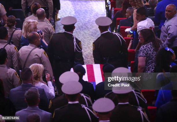 Pallbearers guide in the casket of Las Vegas police officer Charleston Hartfield during his funeral, October 20, 2017 in Henderson, Nevada. Hartfield...