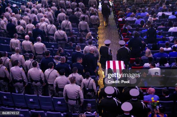 Pallbearers guide in the casket of Las Vegas police officer Charleston Hartfield during his funeral, October 20, 2017 in Henderson, Nevada. Hartfield...