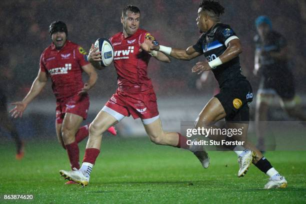 Scarlets scrum half Gareth Davies breaks past Anthony Watson to set up the first try during the European Rugby Champions Cup match between Scarlets...