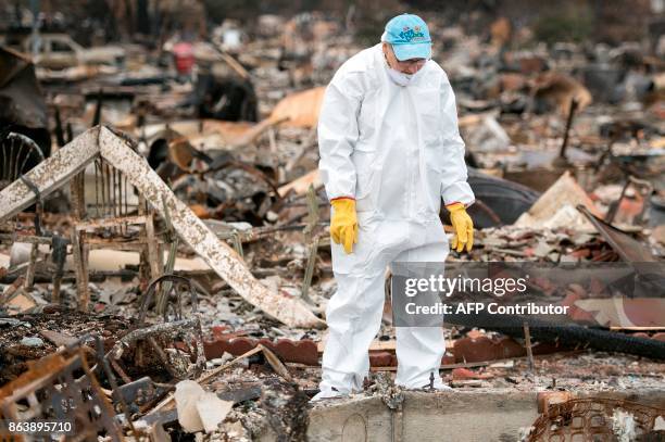 Barbara Wilson Nichols searches through the remains of her burned home in the Coffey Park area of Santa Rosa, California on October 20, 2017....