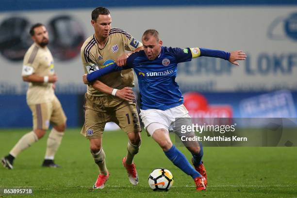 Amaury Bischoff of Rostock battles for the ball with Tim Danneberg of Osnabrueck during the third league match between FC Hansa Rostock and VfL...