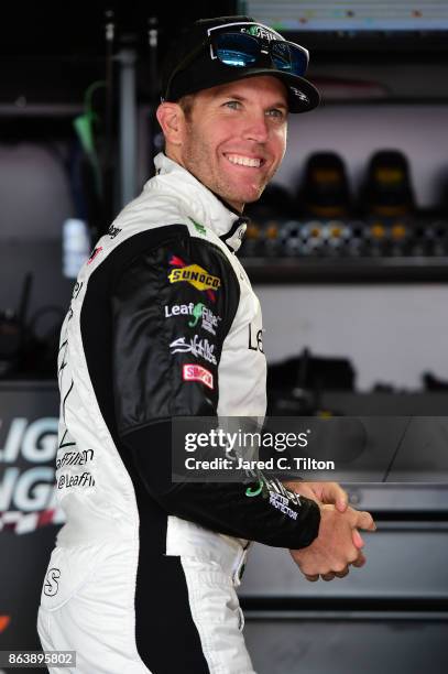 Blake Koch, driver of the Breat Cancer Honor & Remember Chevrolet, stands in the garage area during practice for the NASCAR XFINITY Series Kansas...