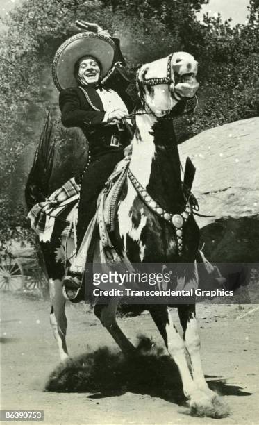 Promotional portrait of Spanish-born American actor Duncan Renaldo as the Cisco Kid on his horse, Diablo, California, 1950s.