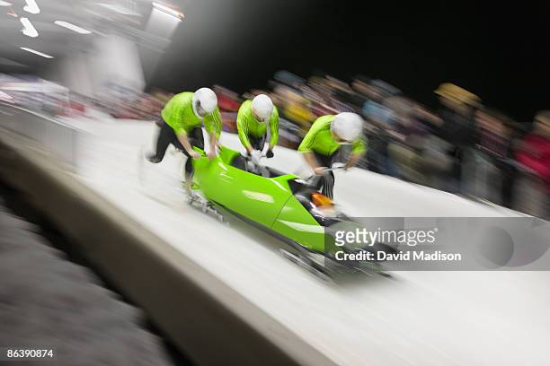 bobsled competition start. - bobsleigh team stock-fotos und bilder