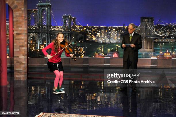 Year-old Dea Devlin from Brooklyn, N.Y. Jumps on a pogo stick and plays a violin while David Letterman looks on during Stupid Human Tricks on the...