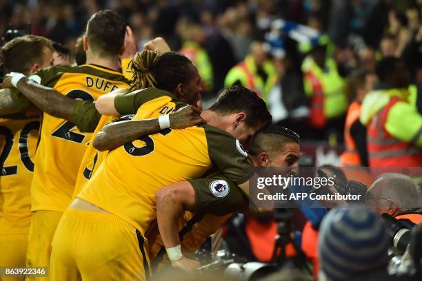 Brighton's French midfielder Anthony Knockaert stares into a photographer's camera as his teammates celebrate after their third goal during the...