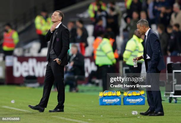 Slaven Bilic, Manager of West Ham United reacts as Chris Hughton, Manager of Brighton and Hove Albion looks on during the Premier League match...