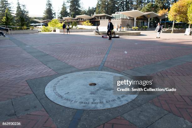 Students walk past a monument to the Free Speech movement in front of Sproul Hall on the campus of UC Berkeley, which includes a symbolic column of...