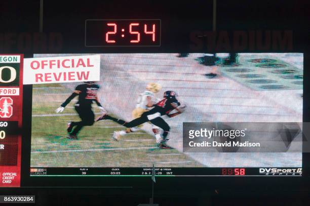 Close up view of the scoreboard video screen during a replay review at Stanford Stadium during an NCAA Pac-12 football game between the Stanford...