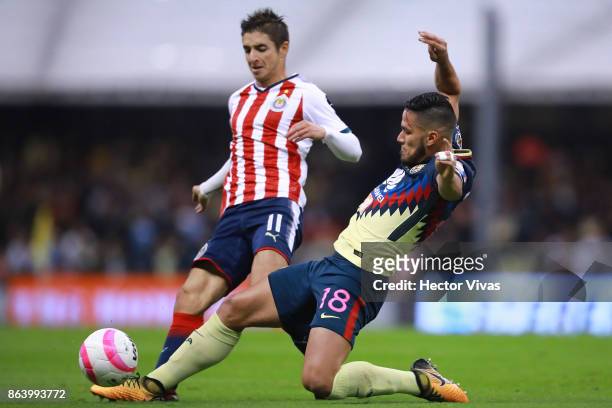 Isaac Brizuela of Chivas struggles for the ball with Bruno Valdez of America during the 10th round match between America and Chivas as part of the...