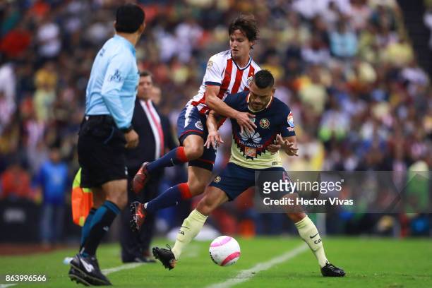 Carlos Fierro of Chivas struggles for the ball with Miguel Angel Samudio of America during the 10th round match between America and Chivas as part of...