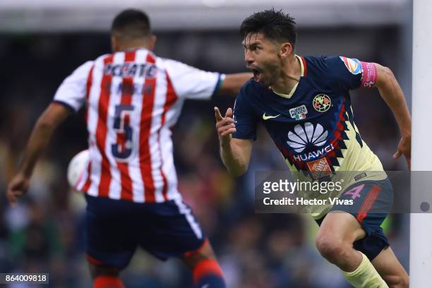 Oribe Peralta of America celebrates after scoring the first goal of his team during the 10th round match between America and Chivas as part of the...