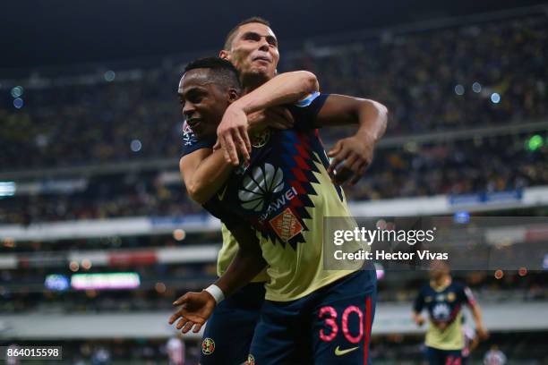 Alex Mina of America celebrates with Paul Aguilar after scoring the second goal of his team during the 10th round match between America and Chivas as...