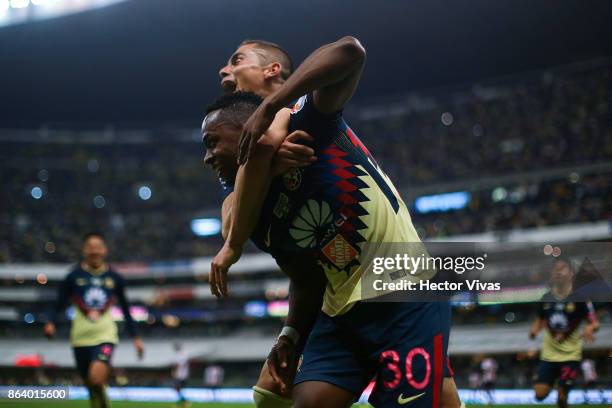 Alex Mina of America celebrates with Paul Aguilar after scoring the second goal of his team during the 10th round match between America and Chivas as...